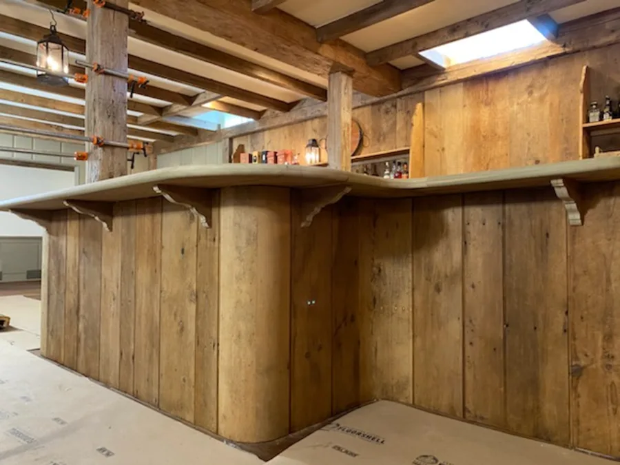 The same curved bar finished in reclaimed wood and installed in a basement